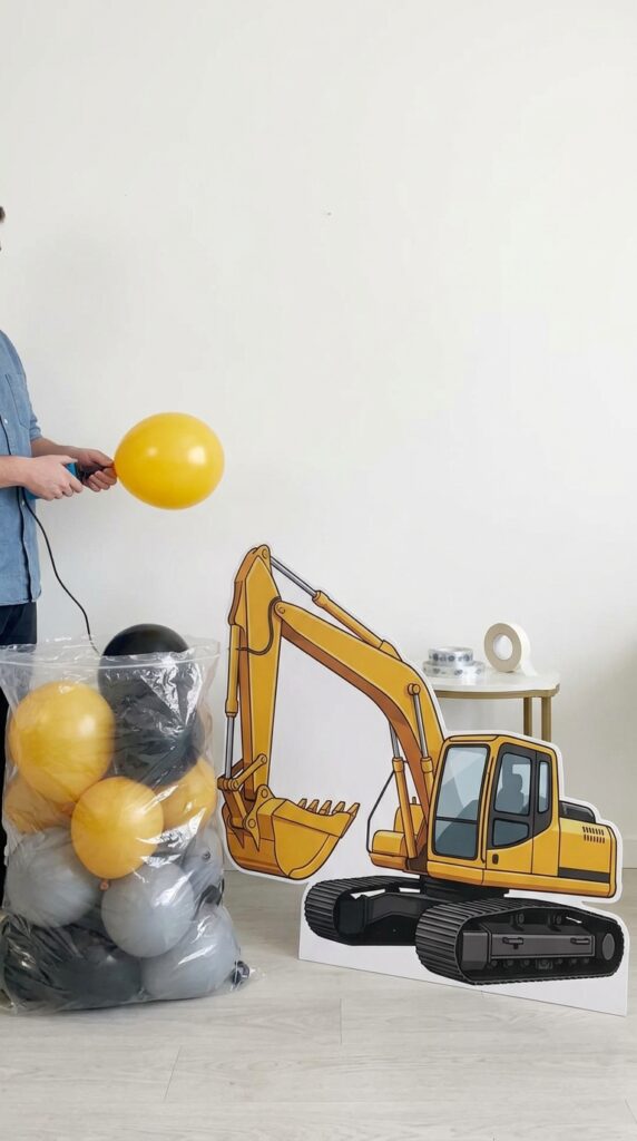 balloon excavator construction birthday backdrop with yellow and black balloons