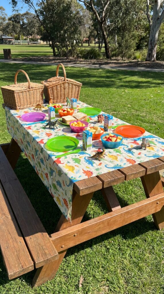 Outdoor dinosaur picnic birthday table setup