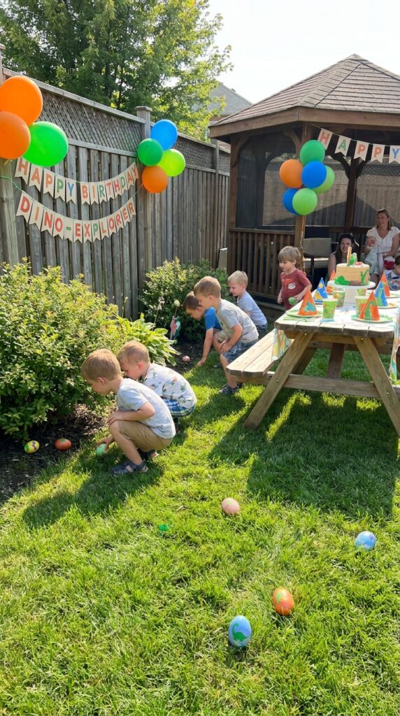 Kids searching for colorful dinosaur eggs in a backyard party setup