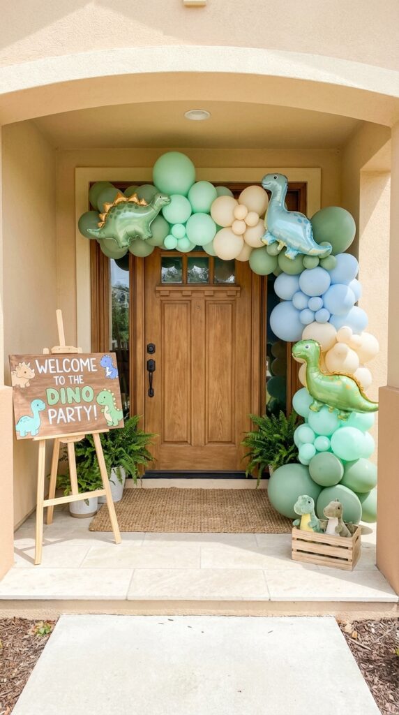 Dinosaur themed party entrance with balloon arch