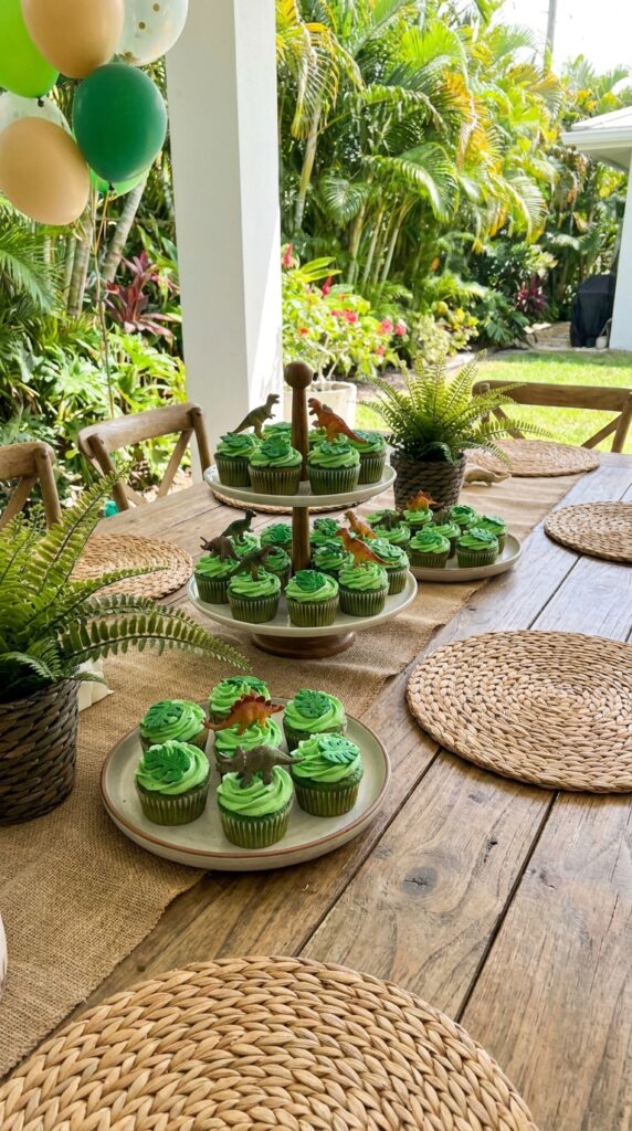 Jungle themed dinosaur cupcakes with green frosting and toppers