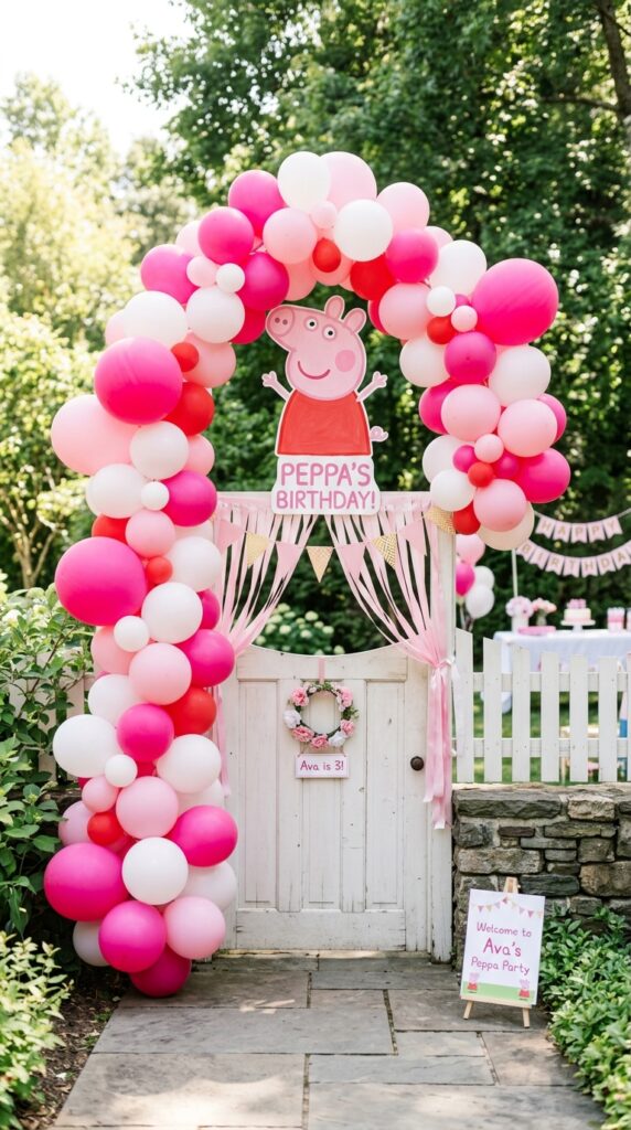 Peppa Pig balloon arch entrance with pink and white balloons above a party door