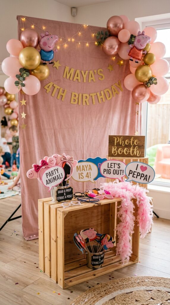 Peppa Pig birthday photo booth with pink backdrop, balloons, props and fairy lights