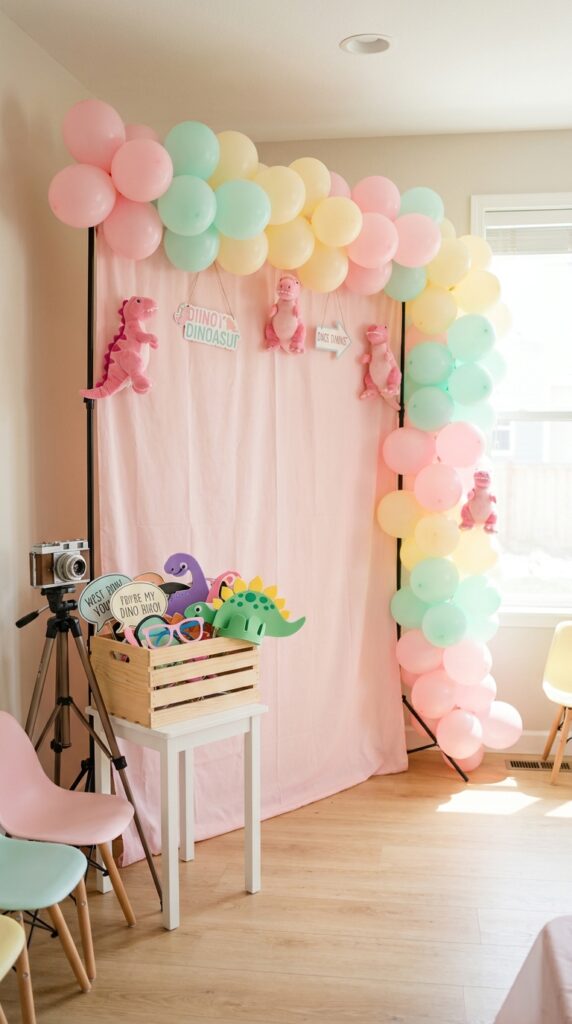 Pink dinosaur themed photo booth corner