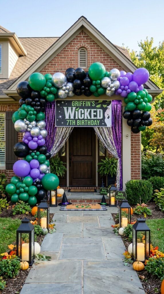 Emerald green Wicked birthday party entrance with balloon arch and magical decorations