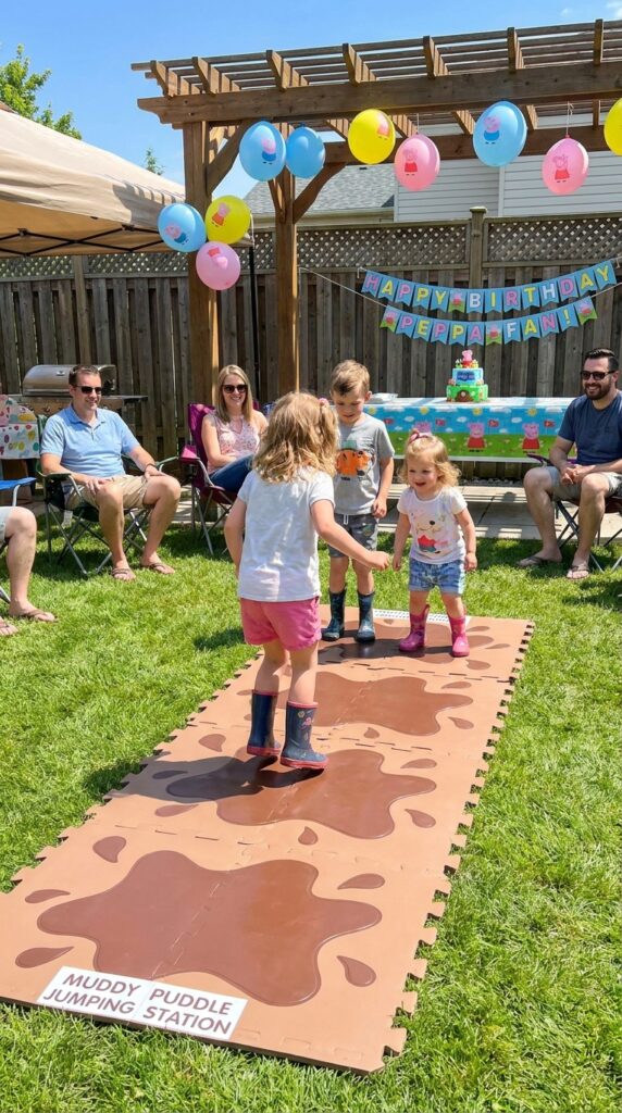 Kids jumping across muddy puddle decorations at a Peppa Pig birthday party activity station.