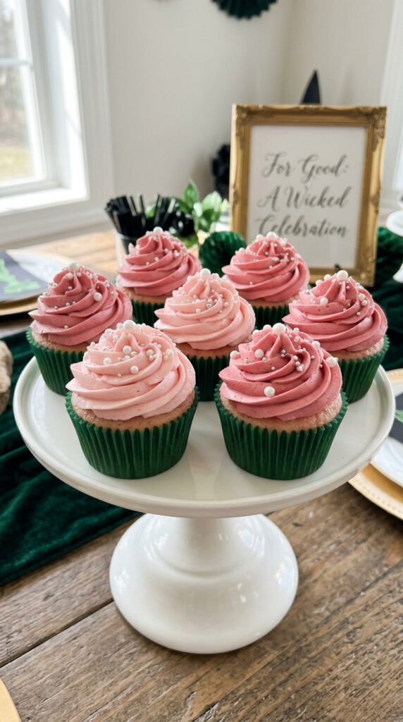 Ombre pink frosting cupcakes for elegant Wicked birthday party desserts.