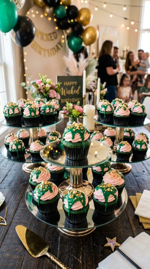 Emerald drip cupcakes with pink frosting for Wicked birthday desserts.