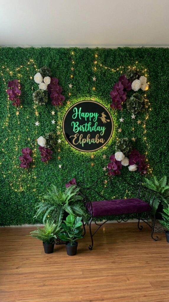 Emerald forest birthday backdrop wall for a Wicked first birthday party.